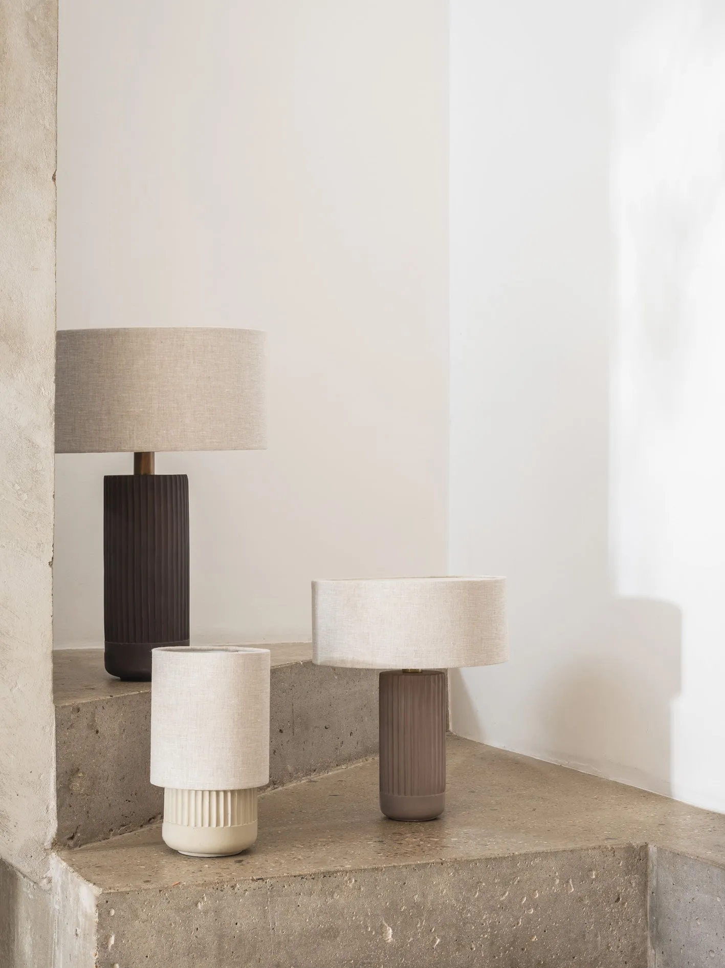 Enza - warm white ribbed concrete table lamp