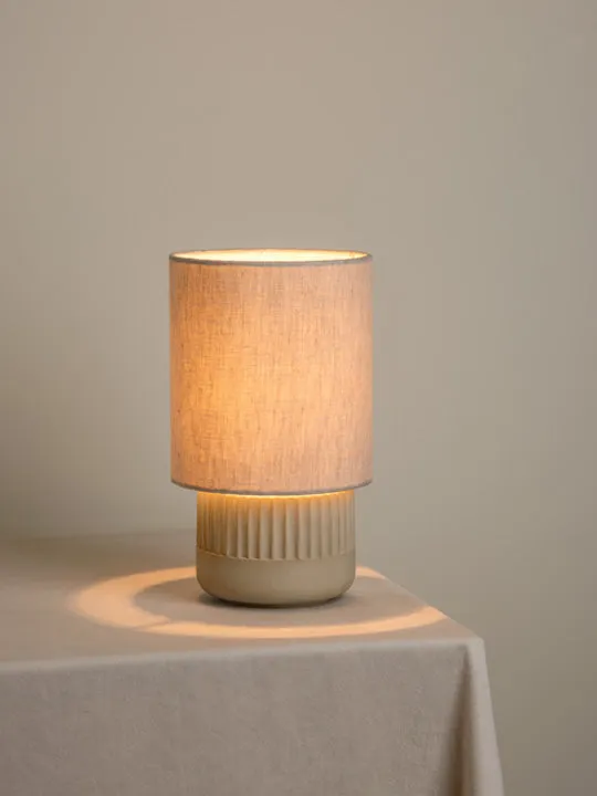 Enza - warm white ribbed concrete table lamp